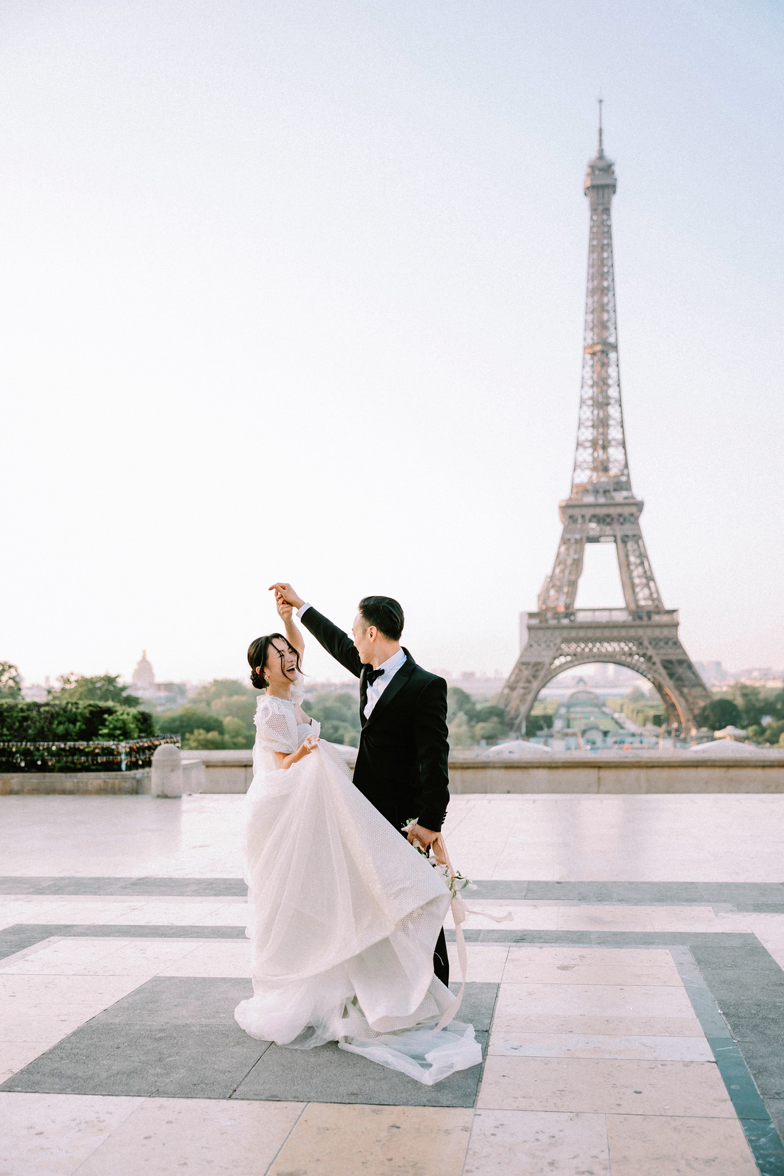 Couple spinning at Trocadero for a Paris Wedding Photographer